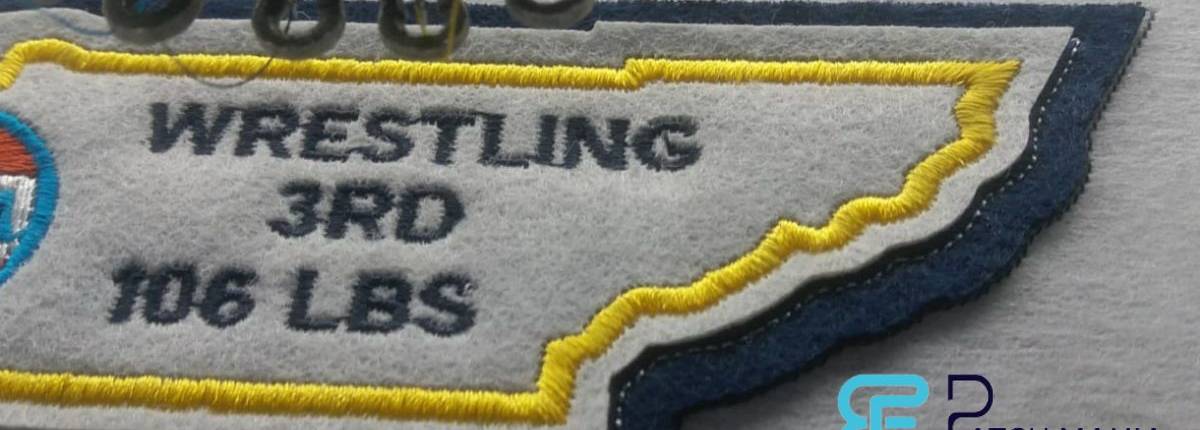 a double felt die cut sports patch under embroidery needles