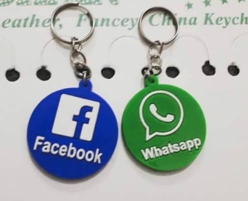 both keychains together in round next to each other on white printed paper with rings lying up for facebook in blue and whats in green