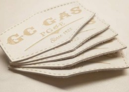 a set of 5 custom leather patches in white buffalo skin genuine embossed with cnc created mold brand name that says GC GAS PG & E SINCE 1922, stitching line available on the border