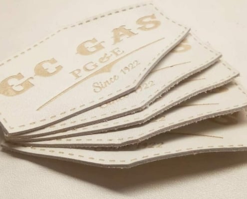 a set of 5 custom leather patches in white buffalo skin genuine embossed with cnc created mold brand name that says GC GAS PG & E SINCE 1922, stitching line available on the border