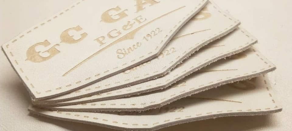 a set of 5 custom leather patches in white buffalo skin genuine embossed with cnc created mold brand name that says GC GAS PG & E SINCE 1922, stitching line available on the border 