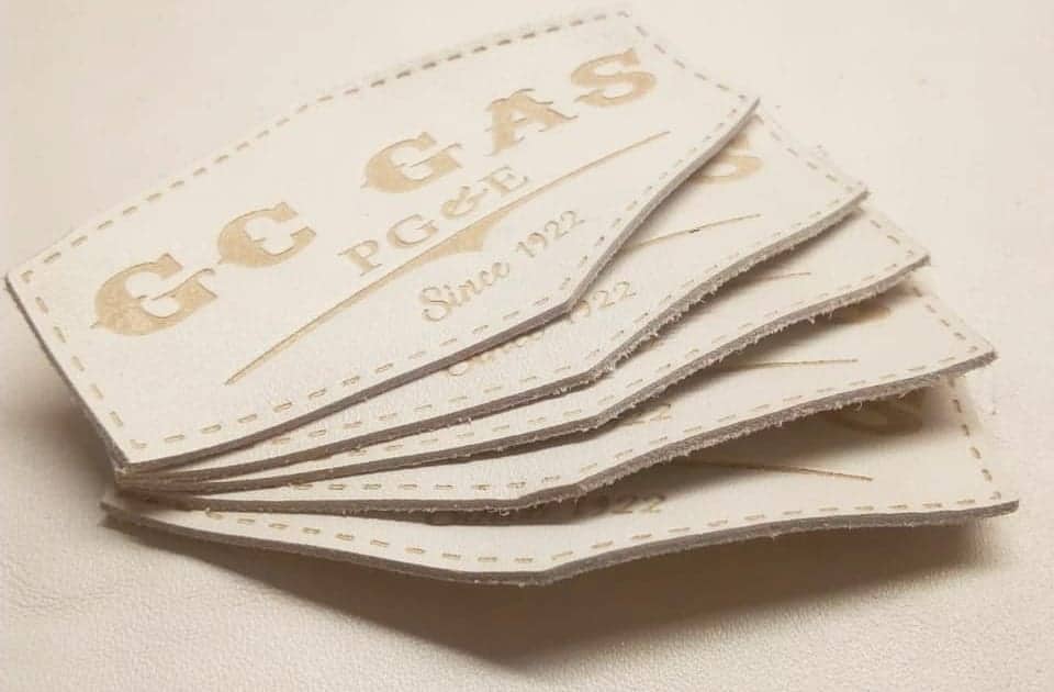 a set of 5 custom leather patches in white buffalo skin genuine embossed with cnc created mold brand name that says GC GAS PG & E SINCE 1922, stitching line available on the border