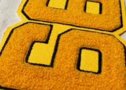 6" wide yellow felt numeric patch for 66 black embroidered edge and gold yellow chenille inside